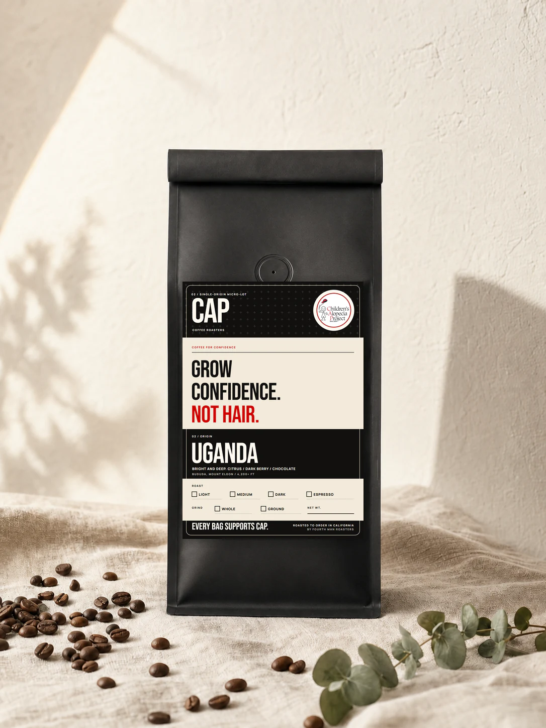 CAP Coffee Roasters Uganda coffee bag with the Grow Confidence, Not Hair label
